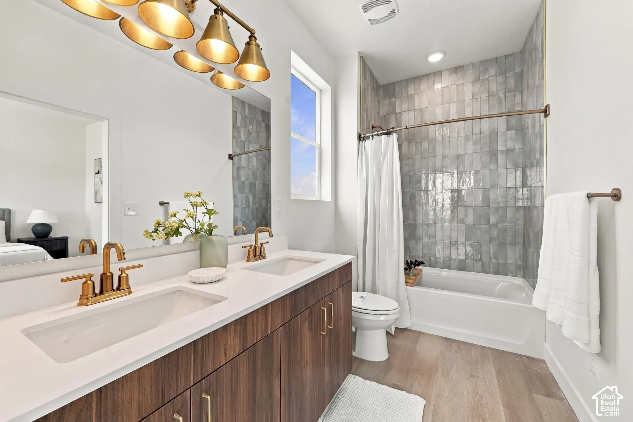 Dual vanity with white countertop and bronze-finish fixtures