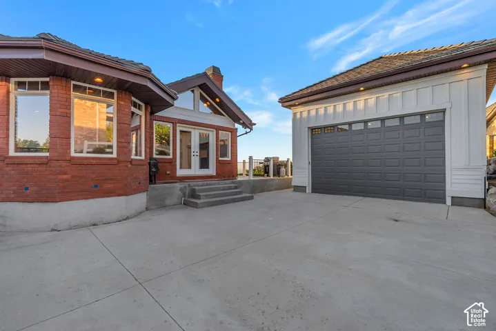 Secured parking behind gate and in front of detached garage.