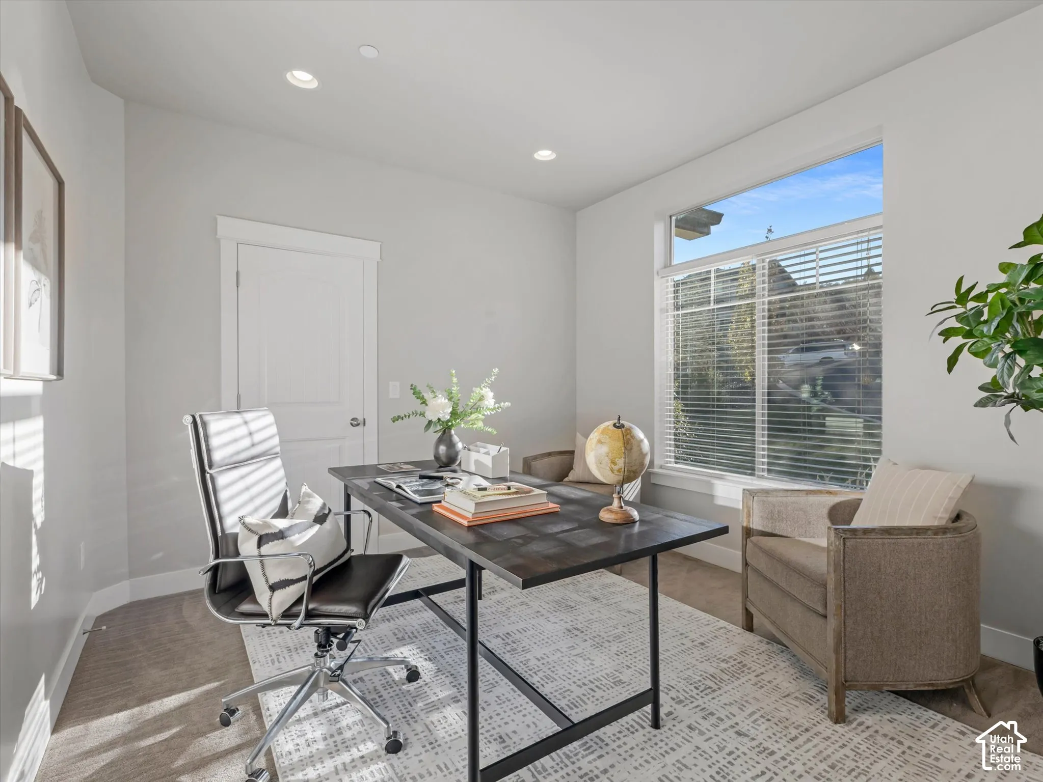 Interior space featuring neutral wall paint, recessed lighting, carpeted flooring, a two-panel interior door, and a large window