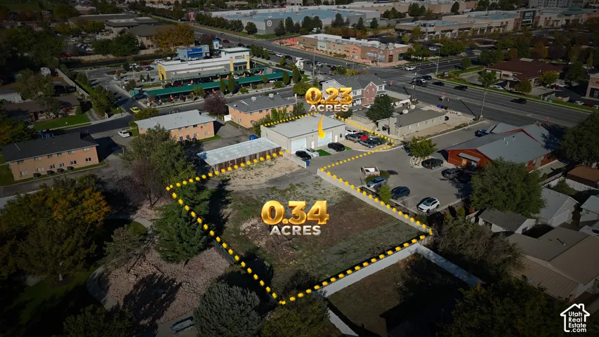 Aerial perspective of a 0.34-acre lot featuring an open parcel of land with paved road access