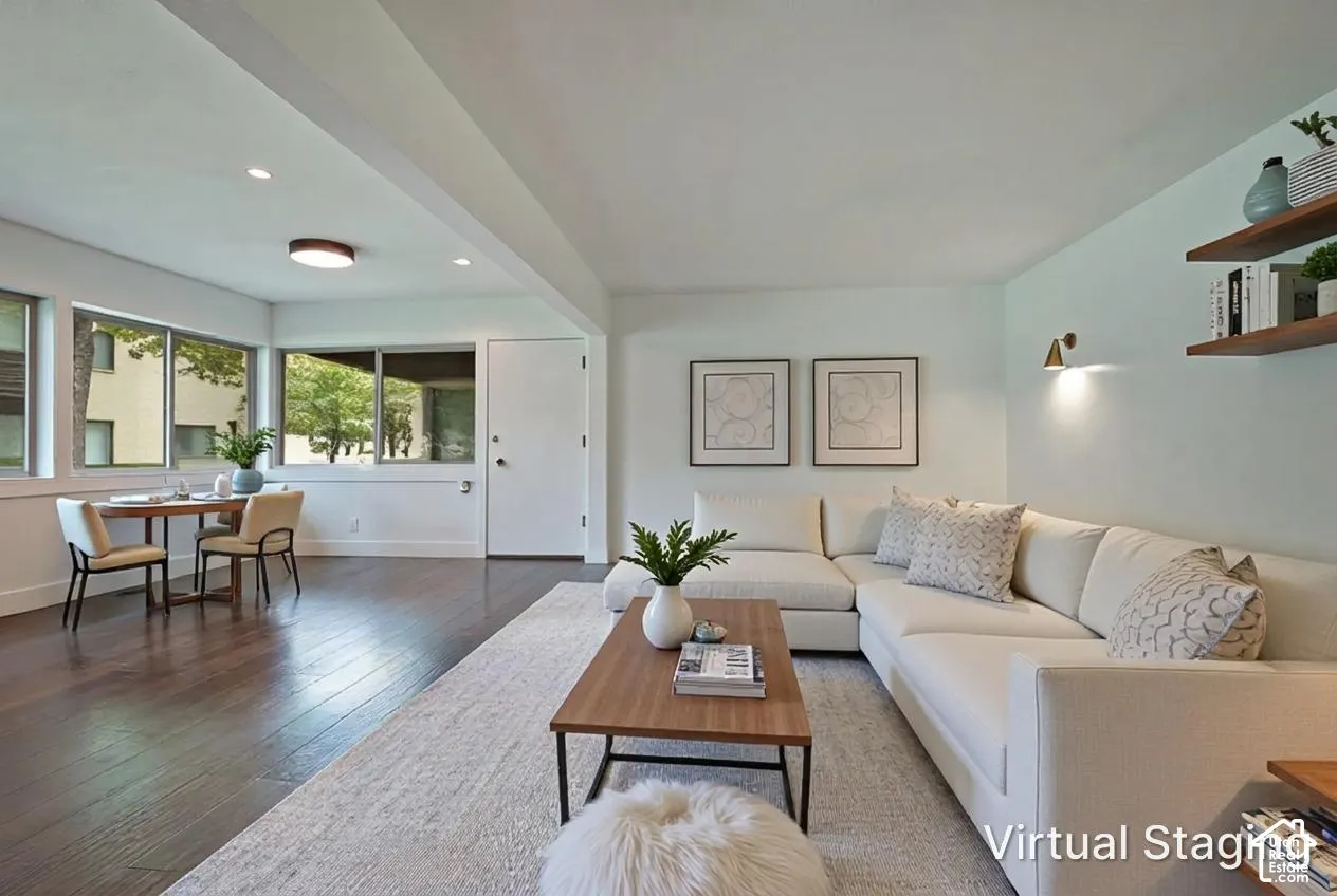 Open-concept living space featuring wood-finish flooring, recessed lighting, expansive multi-pane windows, and built-in wall shelving