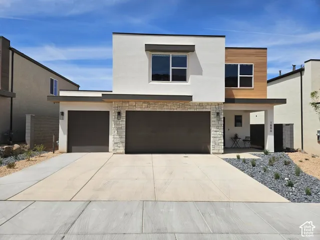*All Pics are of a similar model and finishes*Contemporary exterior featuring smooth stucco finish, natural stone masonry, horizontal wood-tone siding accents, and a multi-car garage