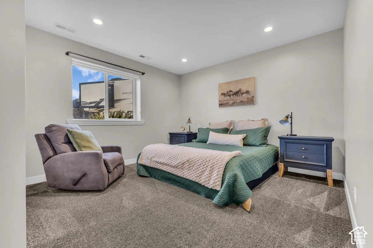 Neutral-toned interior featuring wall-to-wall carpeting, recessed ceiling lighting, and a window with a mountain backdrop