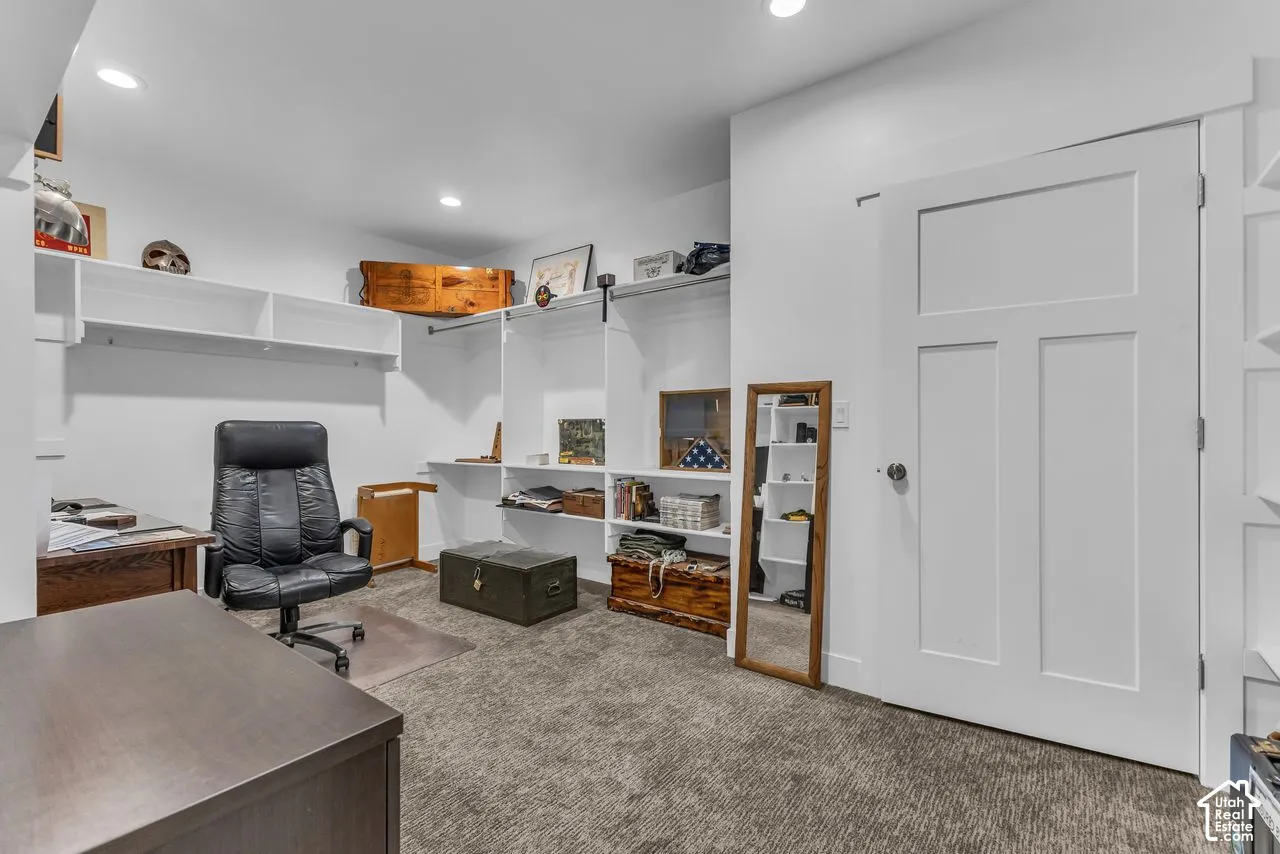 Custom white built-in shelving, integrated closet rod, shaker-style door, and recessed lighting