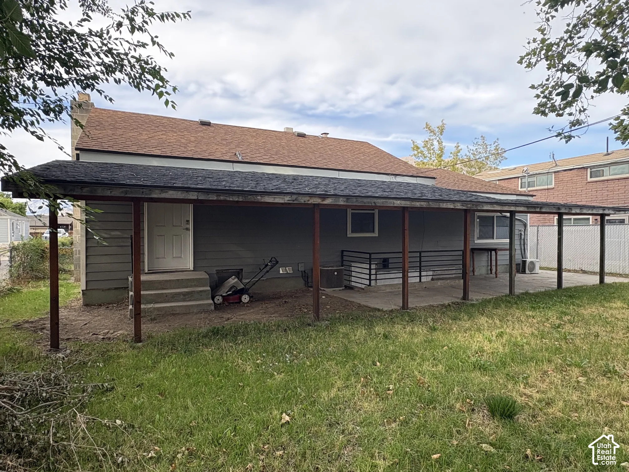 Covered patio featuring an extended roofline, support columns, and concrete flooring