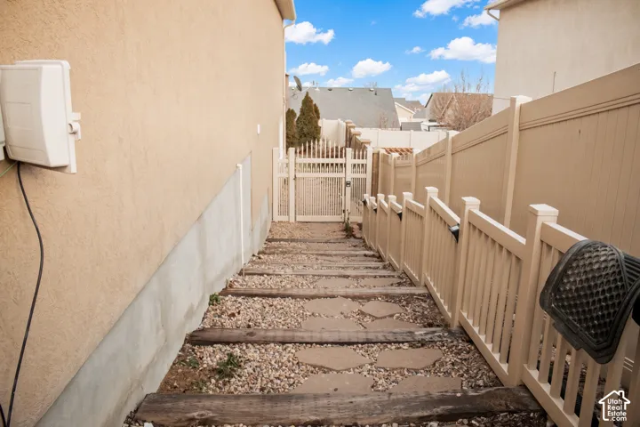 Private side path to the basement apartment's separate entrance