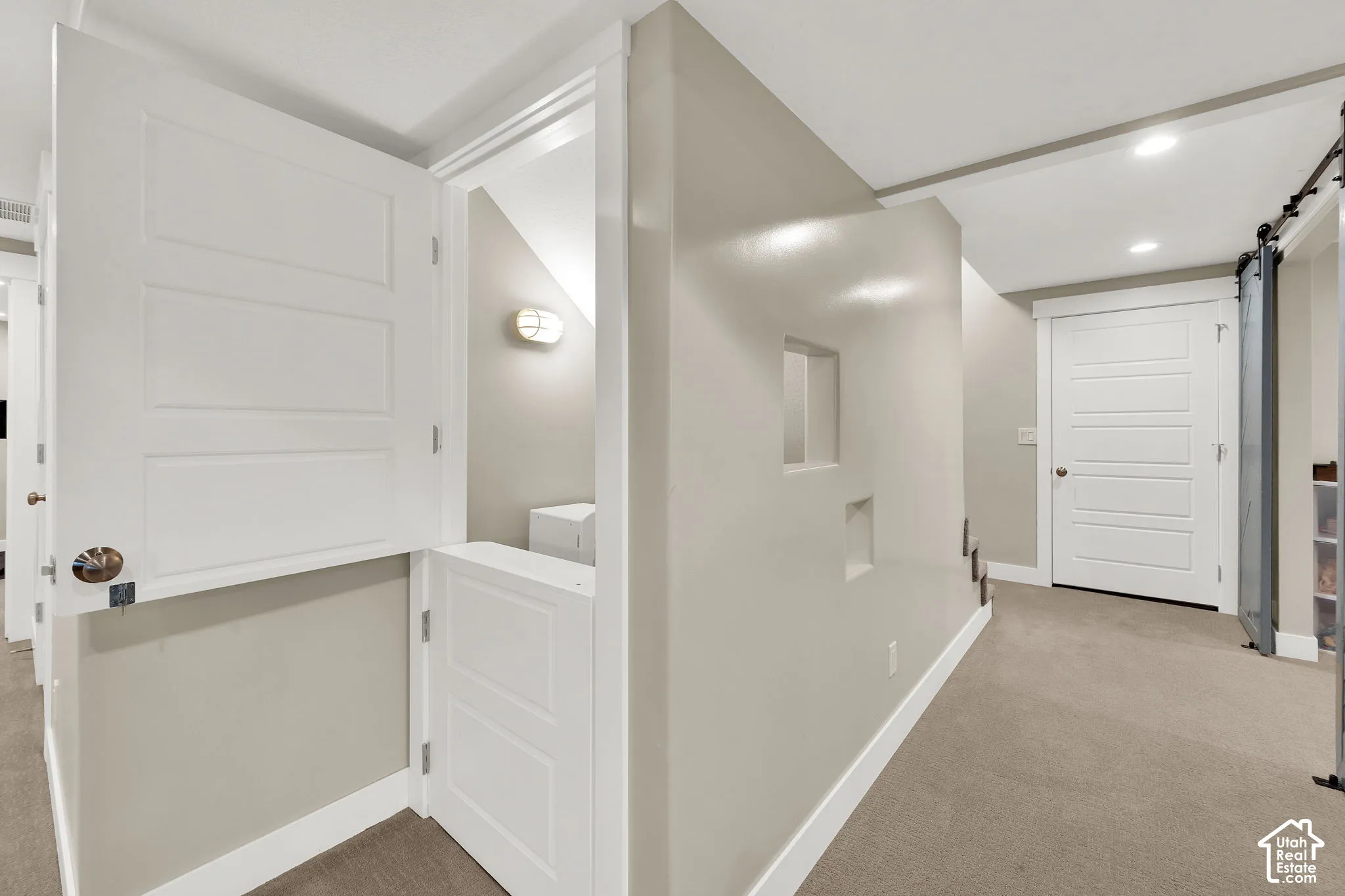 Split-door entry, recessed wall niches, neutral wall palette, interior panel doors, and recessed lighting