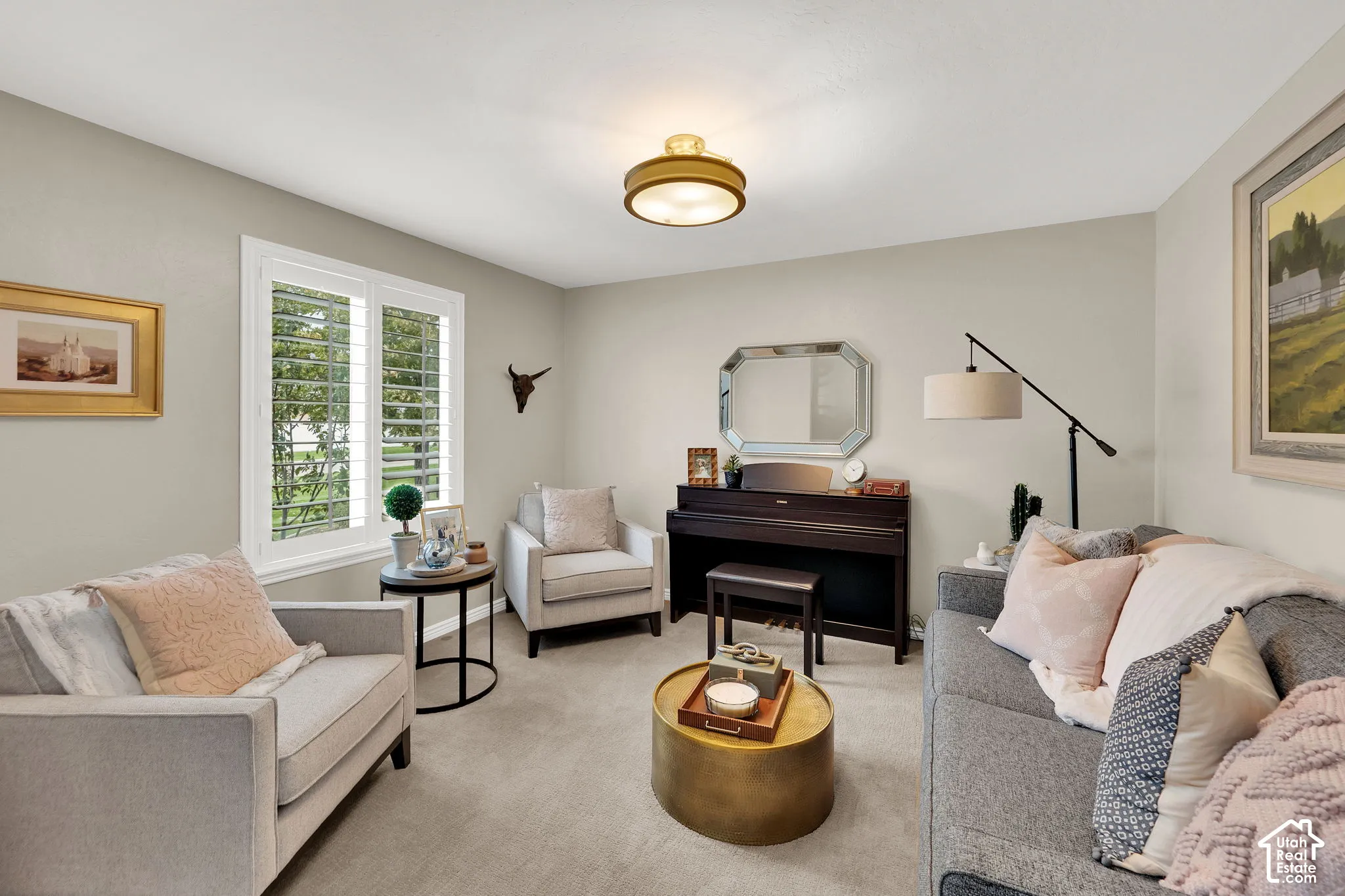 Neutral interior featuring wall-to-wall carpeting, white-framed shutters, and a modern circular ceiling light fixture