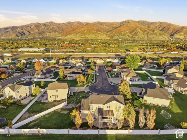 Aerial perspective of residential neighborhood featuring expansive mountain backdrop and mature landscaping