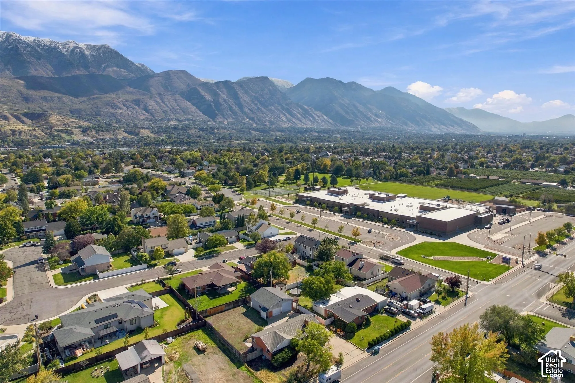 Aerial perspective featuring a prominent mountain backdrop and expansive regional landscape