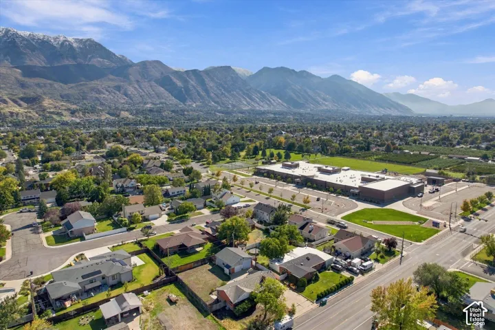 Aerial perspective featuring a prominent mountain backdrop and expansive regional landscape