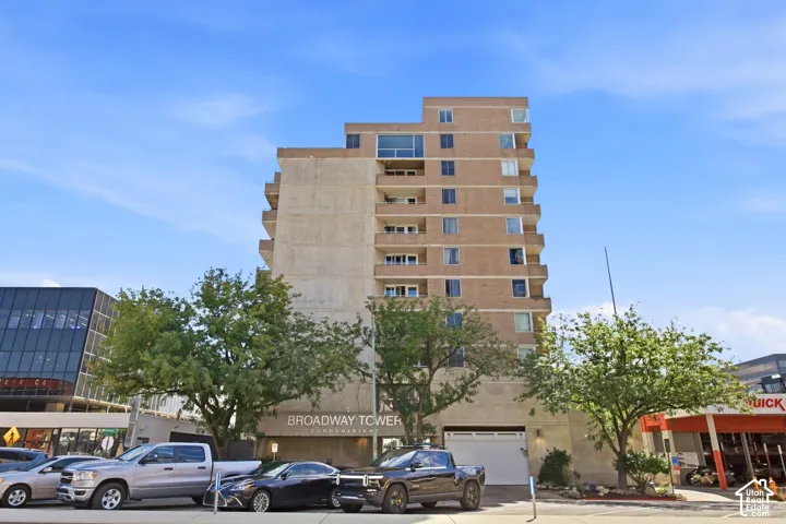 Multi-story brick exterior featuring private balconies and secure ground-level garage access