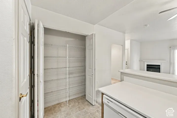 Pantry featuring white wire shelving and bi-fold doors