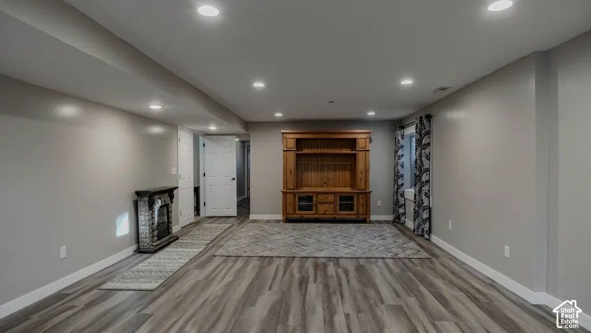 Wood-finish flooring, recessed lighting, and built-in wood cabinetry