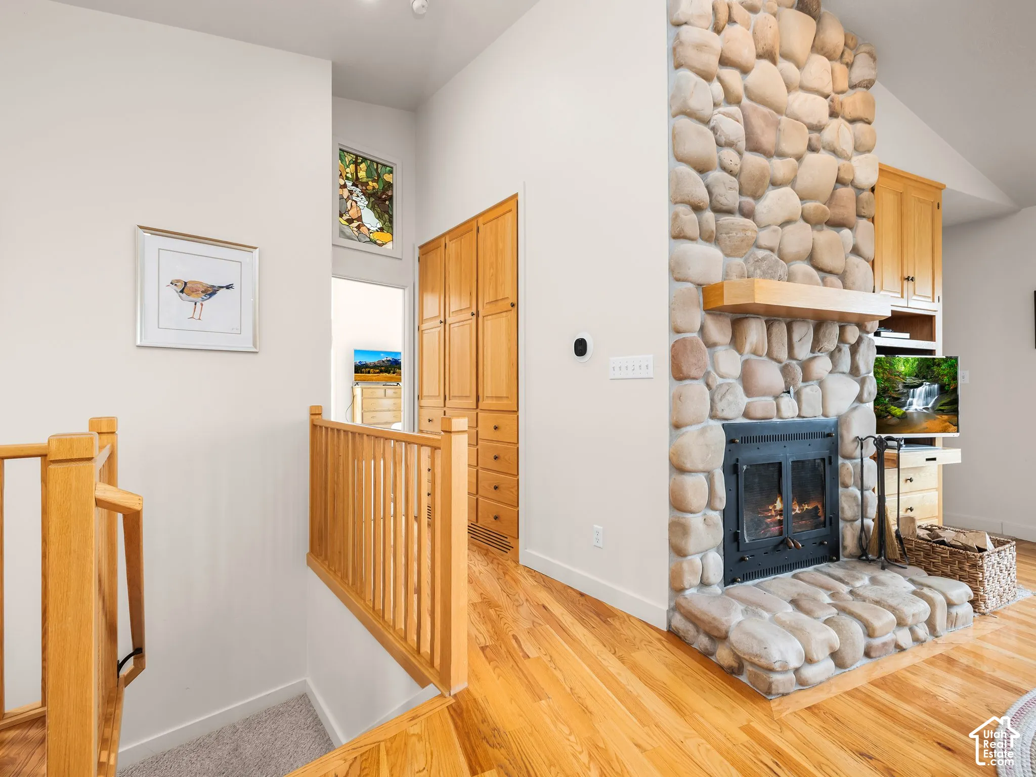 Stone Fireplace, Hallway to master with built in cabinets and stain glass window. Stairs to basement.