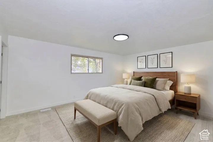 Neutral-toned carpeted flooring, white walls, and a recessed ceiling light fixture
