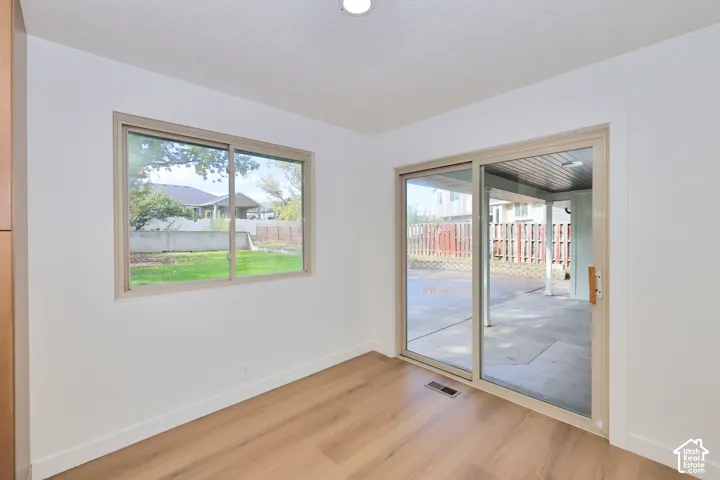 Interior space featuring wood-finish flooring, recessed lighting, a sliding glass door, and a horizontal sliding window