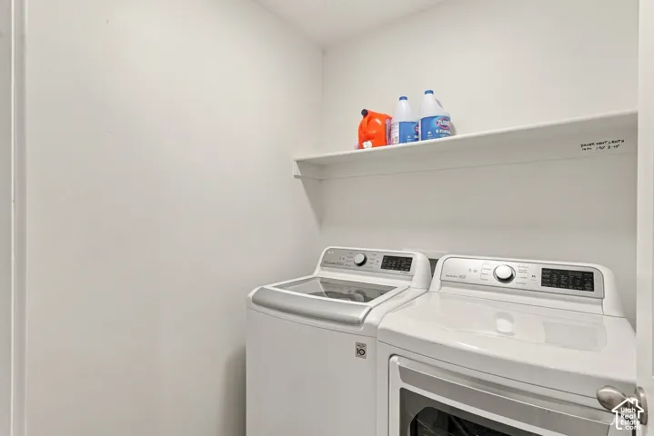 Utility space featuring a built-in white overhead shelf and dedicated hookups for laundry appliances