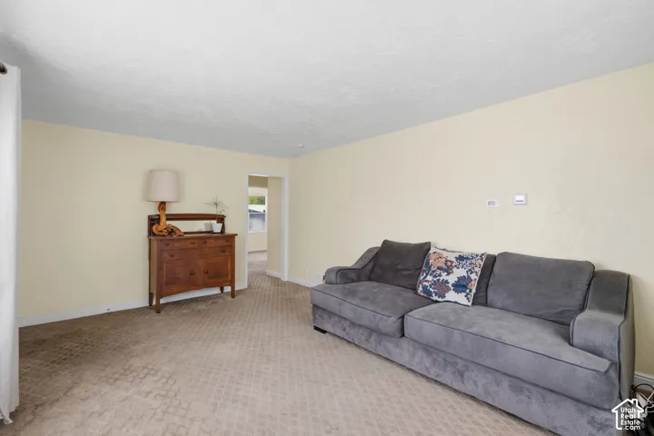 Living area featuring wall-to-wall carpeting and neutral-toned wall paint