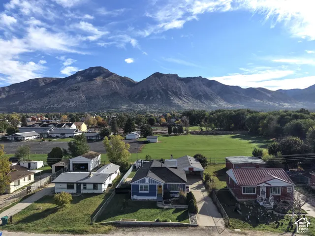 Elevated perspective featuring mountain range scenery and surrounding green space