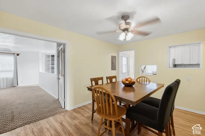 Interior space featuring wood-finish flooring, a ceiling-mounted light fixture with a fan, and dual wall cut-outs