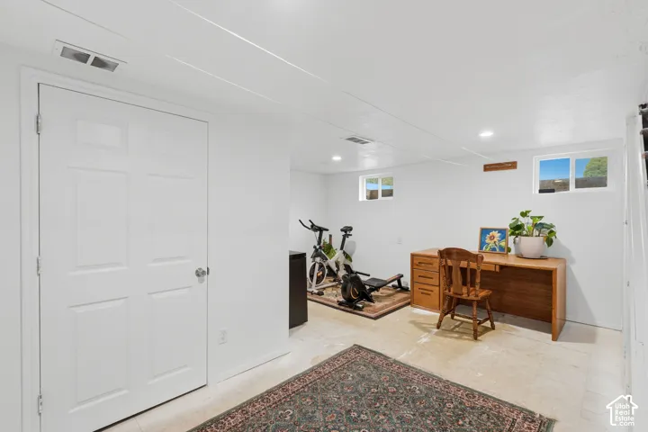 Finished room featuring neutral wall paint, recessed lighting, and dual slider windows