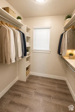 Primary Bedroom: Walk-in closet featuring white built-in shelving, wood-finish flooring, metal garment rods, and a window with blinds. Decoration is digitally altered.
