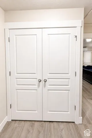 Laundry Room: Double doors featuring a three-panel design, white finish, and brushed nickel hardware