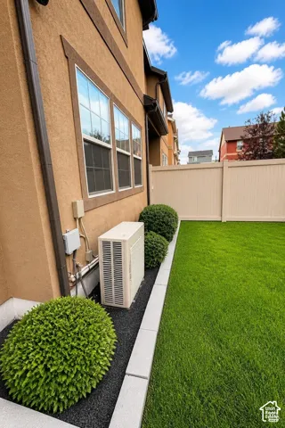 Private backyard featuring a grass lawn, perimeter vinyl fencing, and a white deck. Digitally altered to show with grass.