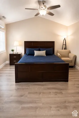 Primary Bedroom: Vaulted ceiling featuring a central brushed-nickel ceiling fan with integrated lighting and wood-finish flooring