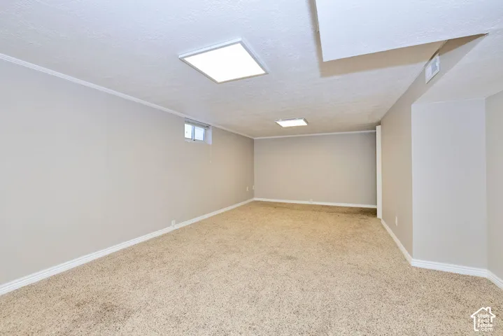 Neutral-toned interior space featuring neutral carpeting, light-colored walls, and two integrated square LED ceiling fixtures
