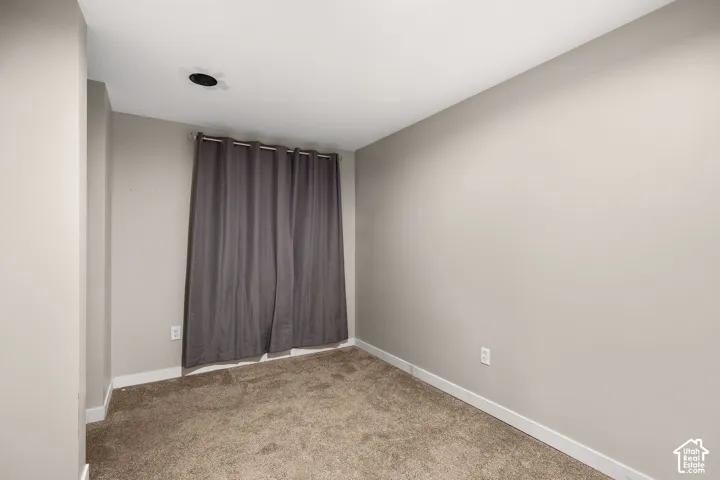 Interior room featuring neutral wall paint and wall-to-wall carpeting
