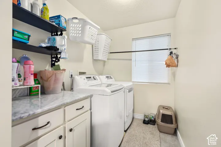 Laundry area featuring built-in cabinetry, stone-finish countertop, black metal wall shelving, and a horizontal hanging rod