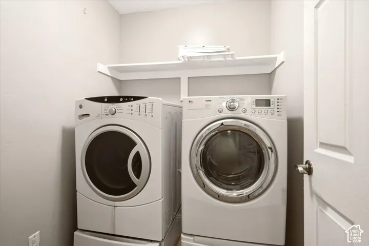 Dedicated laundry area featuring a white built-in storage shelf and a paneled door