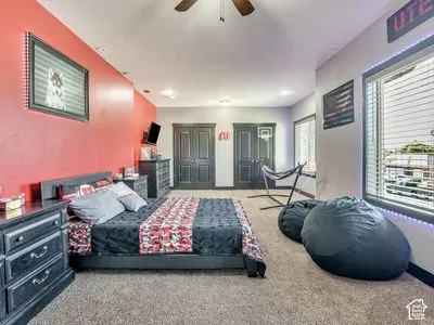 Room featuring wall-to-wall carpeting, recessed lighting, ceiling fan, and dual closets with dark-finish doors