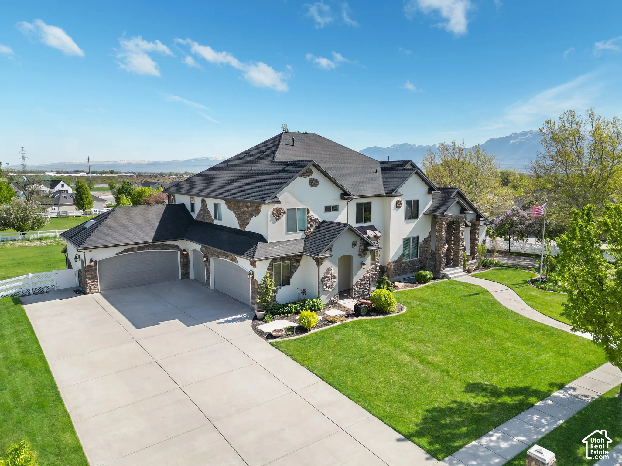 Two-story exterior featuring a stone and stucco fa