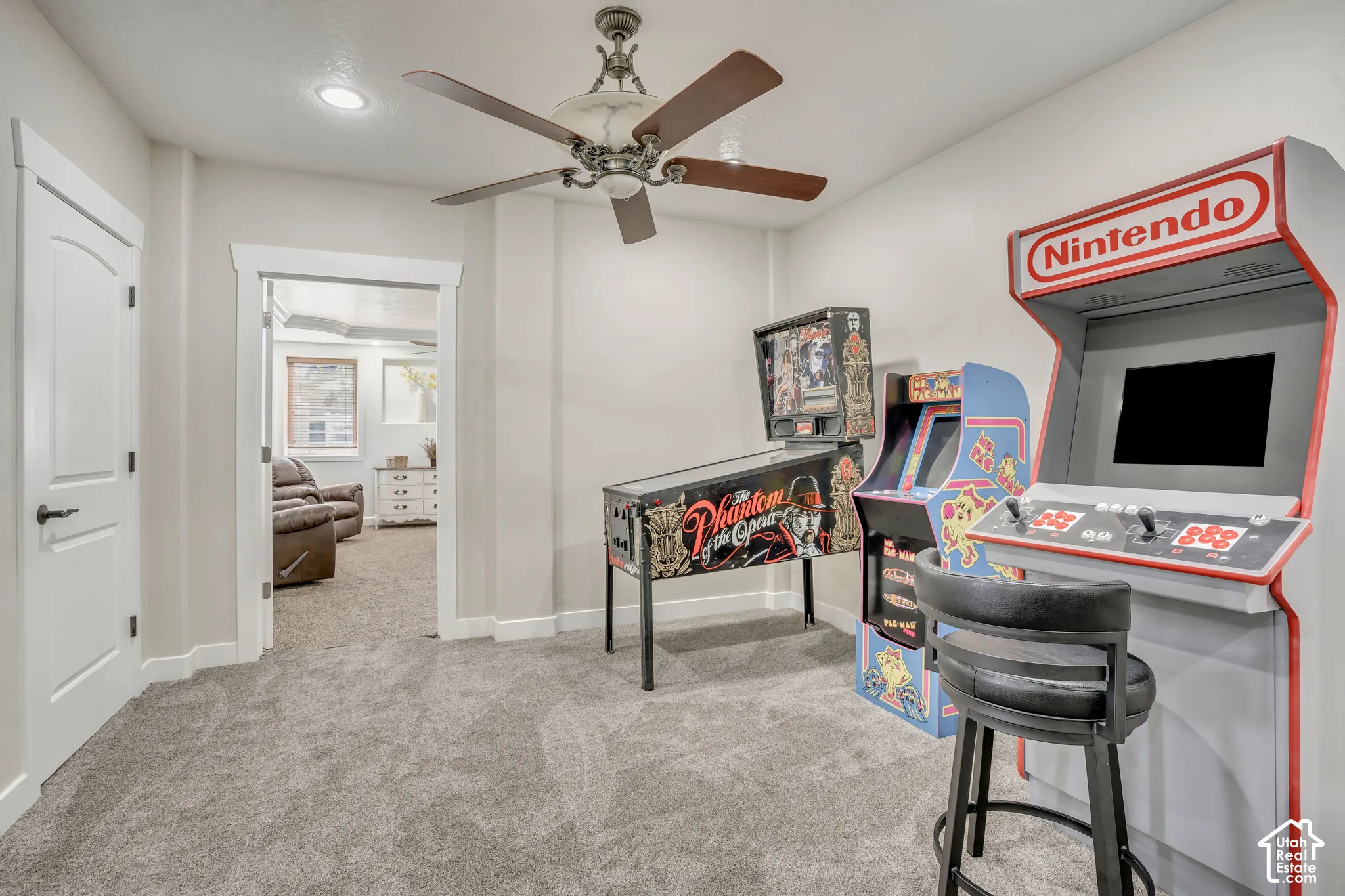Room interior featuring recessed lighting, a ceiling fan with integrated lighting, neutral wall paint, solid-core interior doors with decorative trim, and wall-to-wall carpet