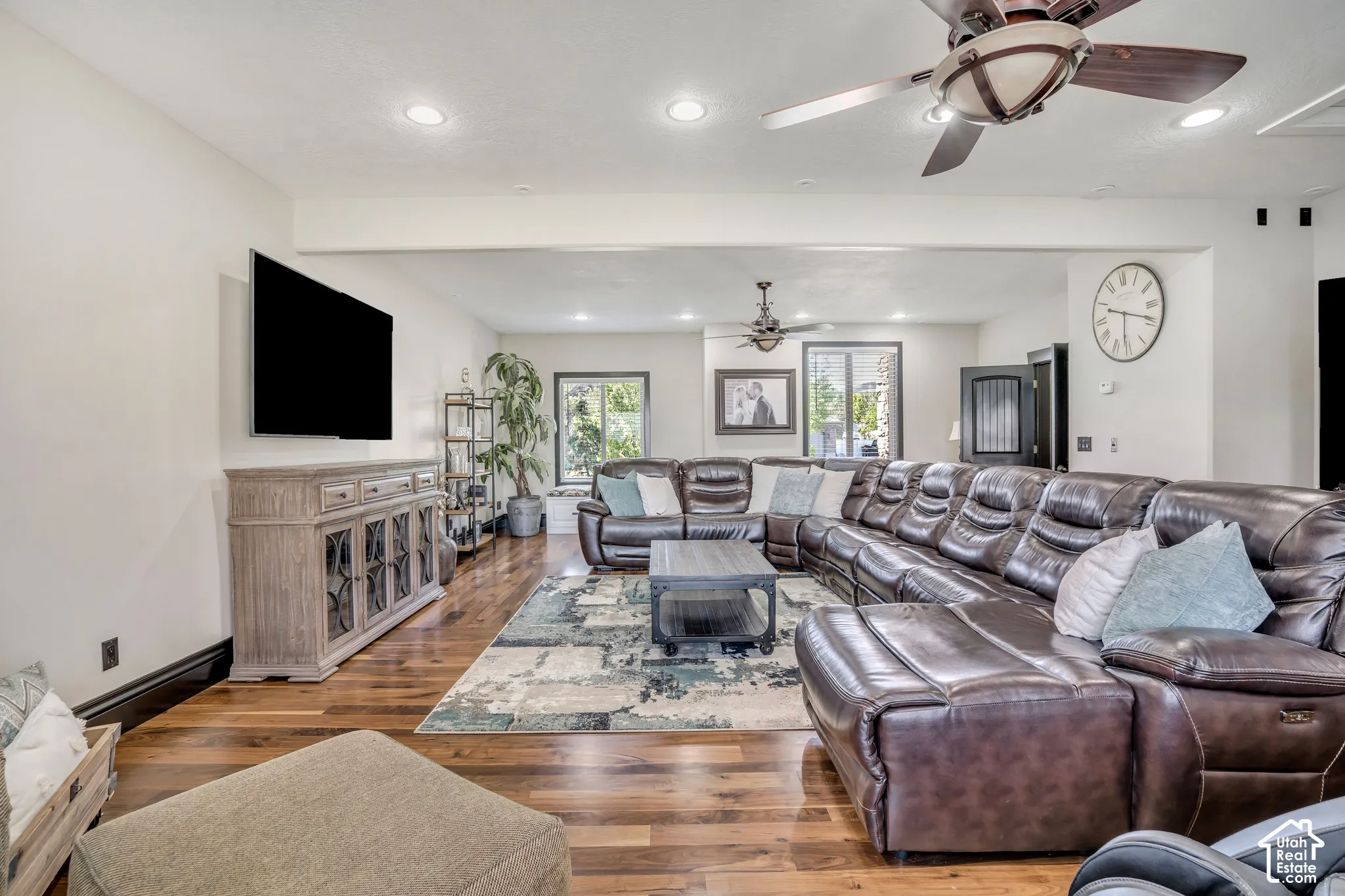 Living area featuring wood-finish flooring, recessed lighting, and dual ceiling fans
