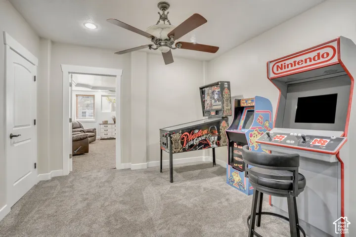 Room interior featuring recessed lighting, a ceiling fan with integrated lighting, neutral wall paint, solid-core interior doors with decorative trim, and wall-to-wall carpet