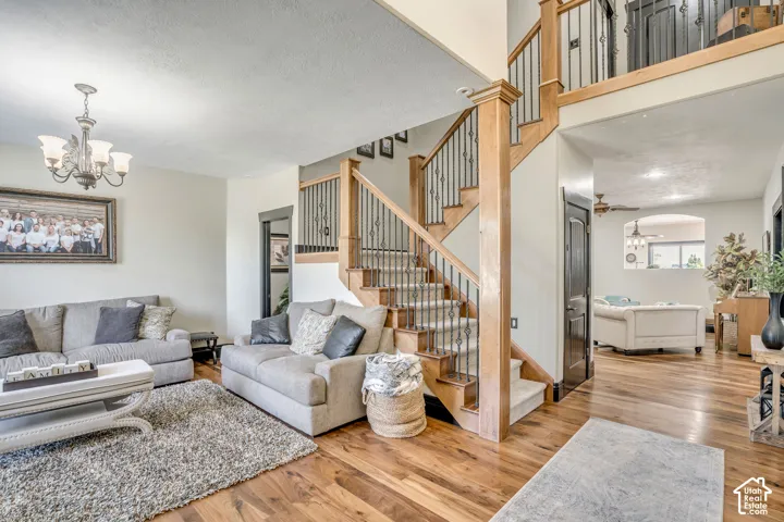 Staircase featuring wood handrails, decorative metal balusters, and carpeted treads