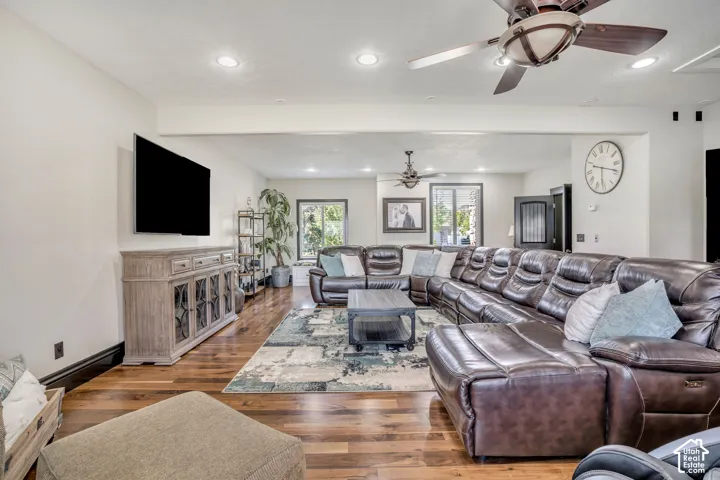 Living area featuring wood-finish flooring, recessed lighting, and dual ceiling fans
