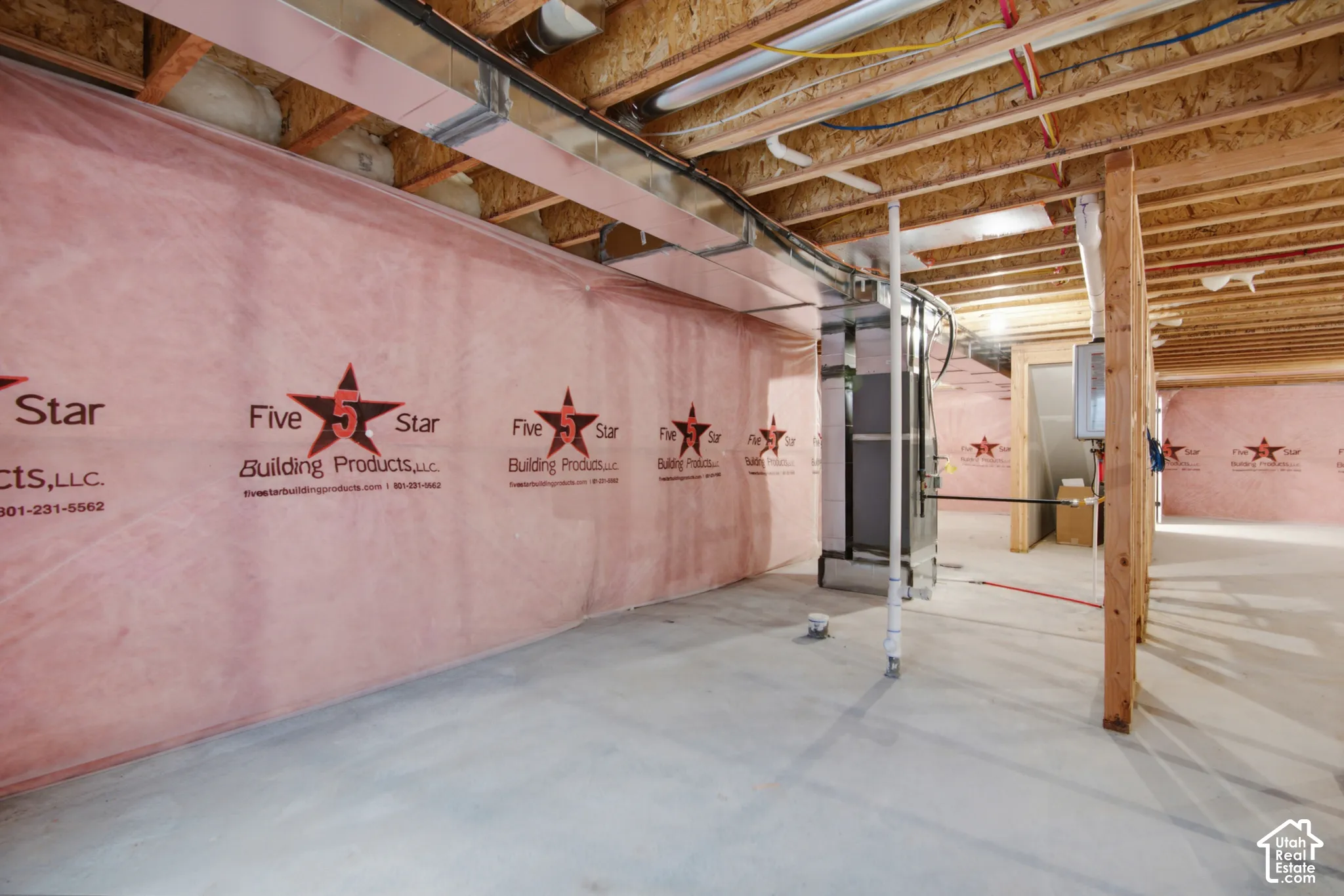 Unfinished lower level featuring concrete flooring, exposed wooden ceiling joists, vapor-barrier insulated walls, and integrated HVAC ductwork