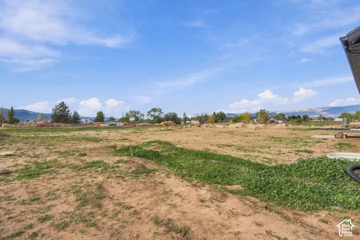 Expansive lot featuring open terrain and prominent mountain horizon