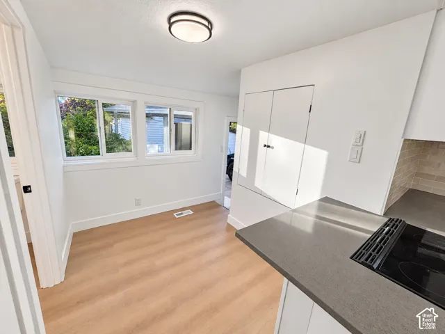 Wood-finish flooring, solid-surface countertops, built-in cabinetry, dual-pane windows, and inset ceiling lighting