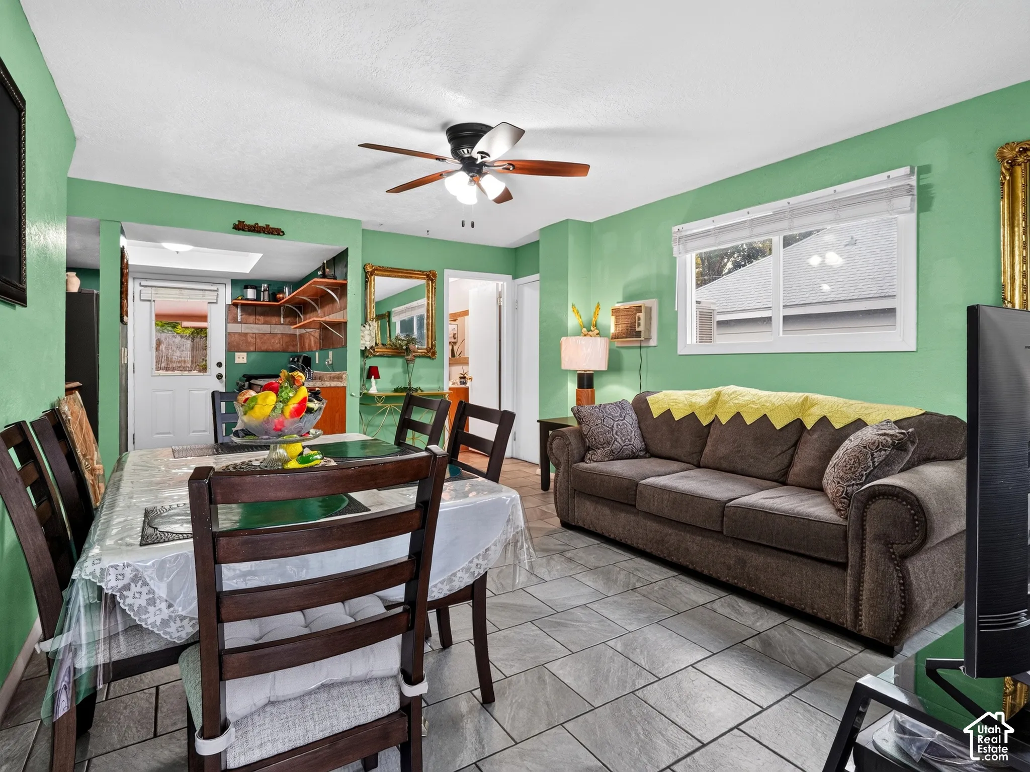 2 bedroom unit - Tile flooring, ceiling fan with integrated lighting, and natural light from a window with horizontal blinds