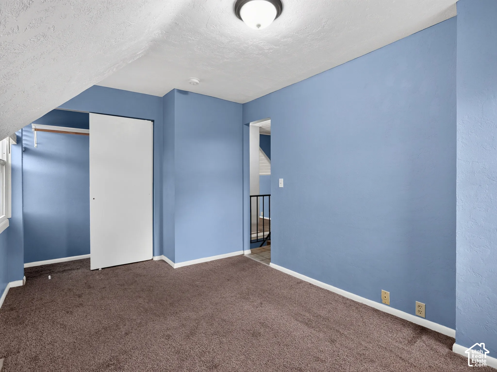 1 bedroom unit - Bedroom featuring vaulted ceilings, wall-to-wall carpeting, and a built-in closet with sliding doors