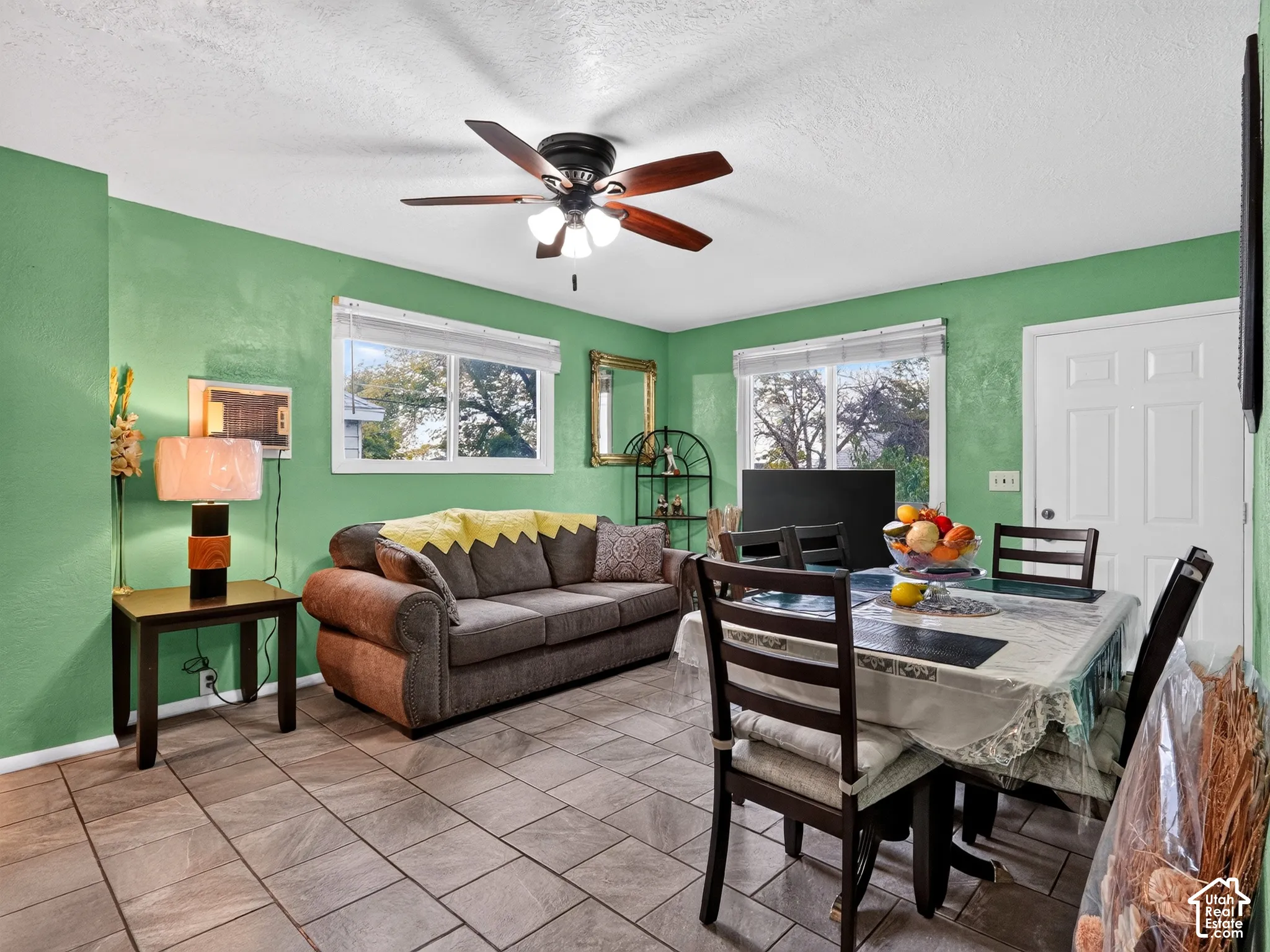 2 bedroom unit - Neutral-toned tiled flooring, multi-light ceiling fan, and two windows providing natural illumination