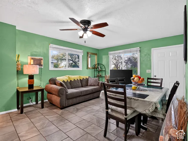 2 bedroom unit - Neutral-toned tiled flooring, multi-light ceiling fan, and two windows providing natural illumination