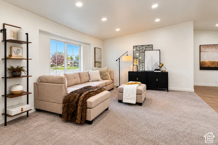 Neutral interior space featuring recessed ceiling lighting, a grid-pattern window, and wall-to-wall carpeting