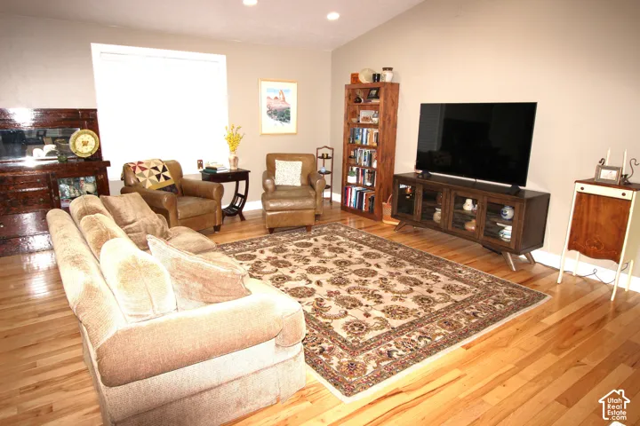 Family Room  area featuring wood-finish flooring, vaulted ceilings, and recessed lighting